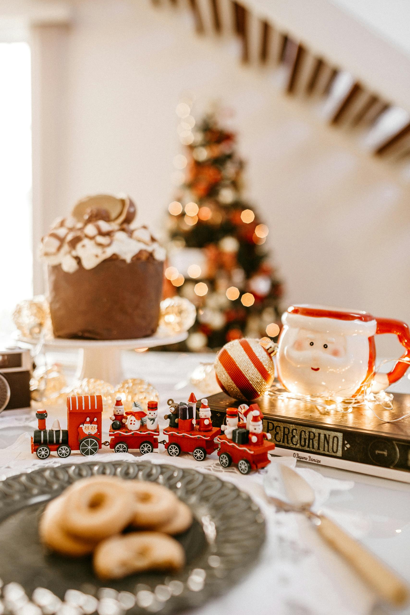 Cozy indoor Christmas scene with Santa mug, treats, and decorations.