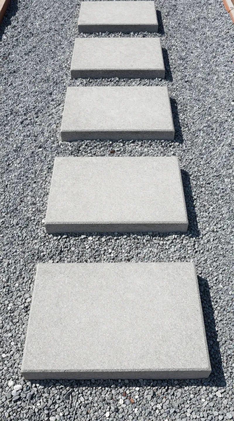 Large concrete stepping stones on fine gravel path