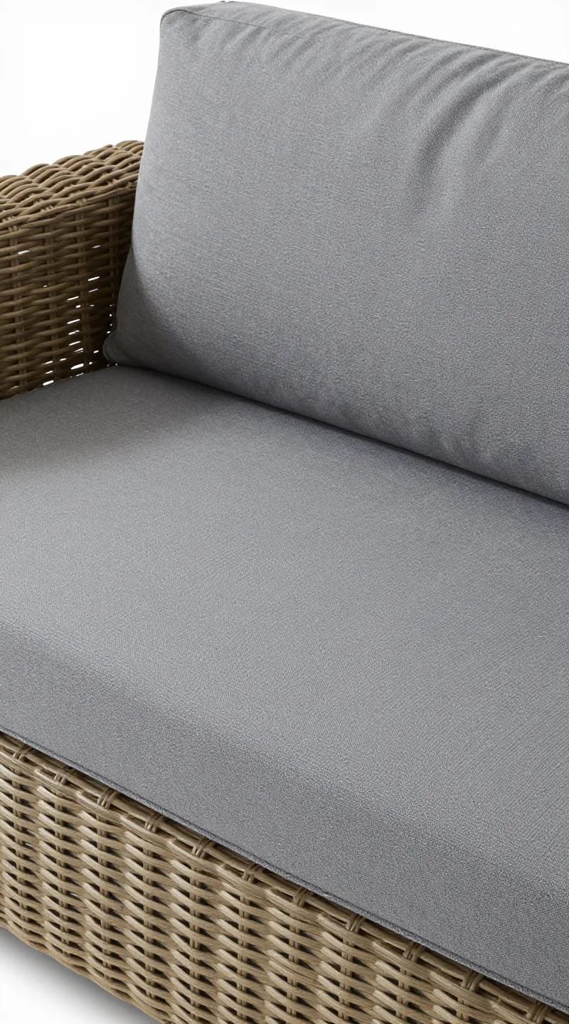 Removable UV-resistant cushion covers on rattan sofa, close-up