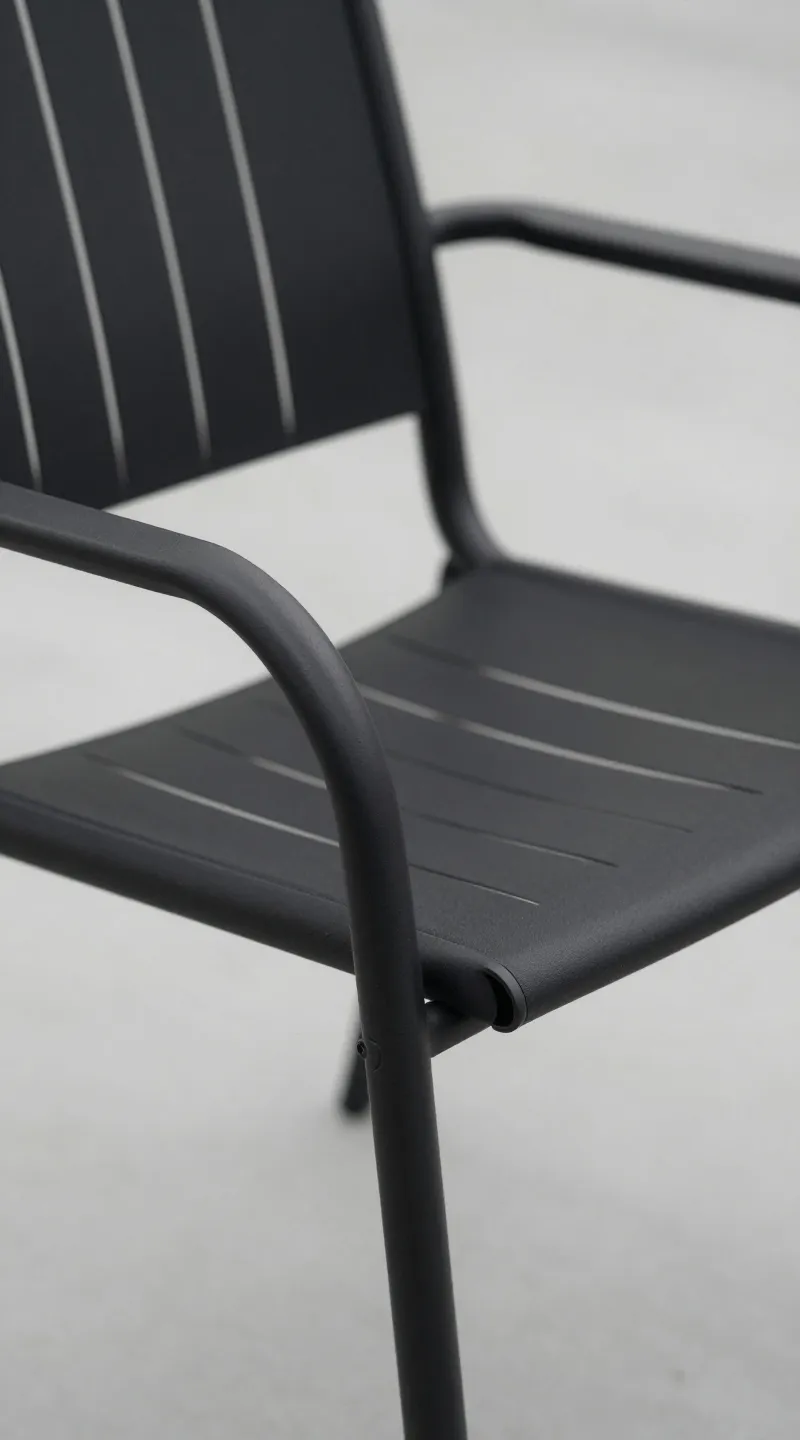 Matte black aluminum patio chair, minimalist lines, close-up